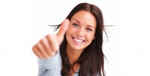 Portrait of attractive young woman showing a thumbs up on white background